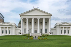 Virginia State Capitol building with white columns and neoclassical architecture on green lawn