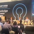 CleanPower conference panel discussion with four speakers seated on stage discussing energy innovation