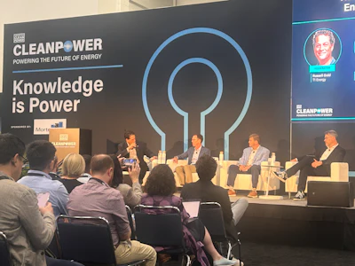 CleanPower conference panel discussion with four speakers seated on stage discussing energy innovation