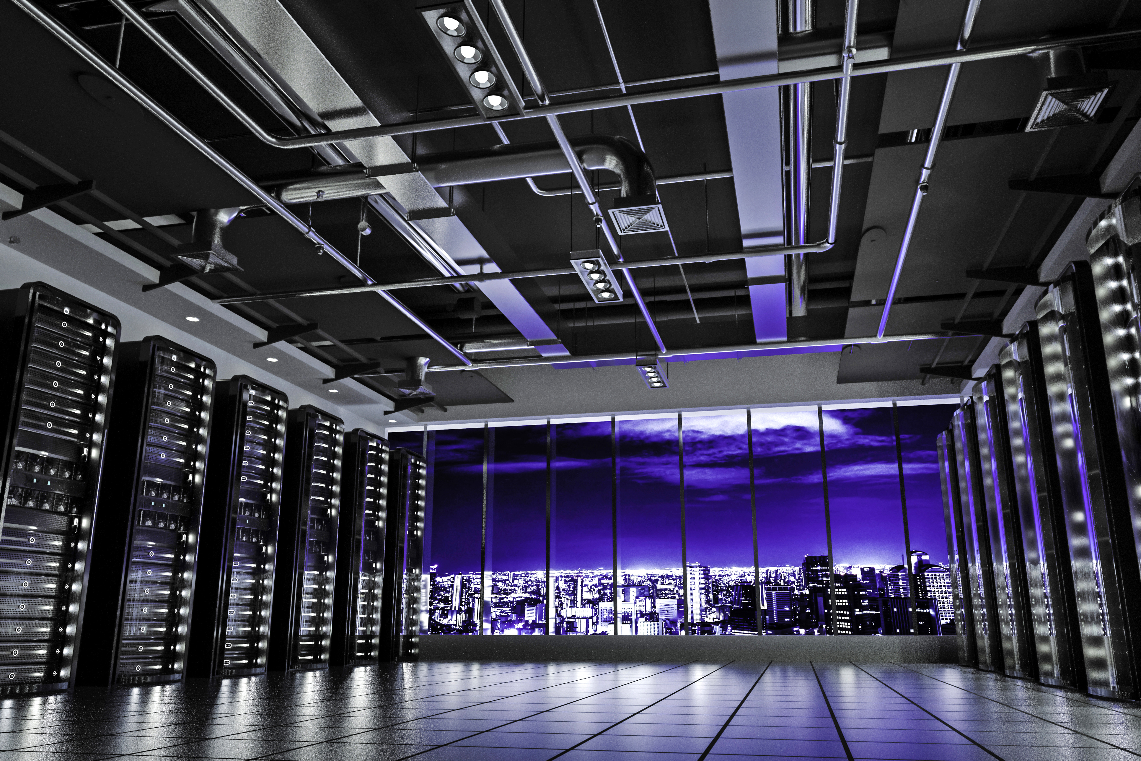 Modern data center with server racks, purple LED lighting, and nighttime city skyline visible through windows