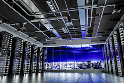 Modern data center with server racks, purple LED lighting, and nighttime city skyline visible through windows