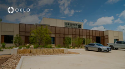 OKLO logo displayed on modern industrial building with brown metal framework and landscaping